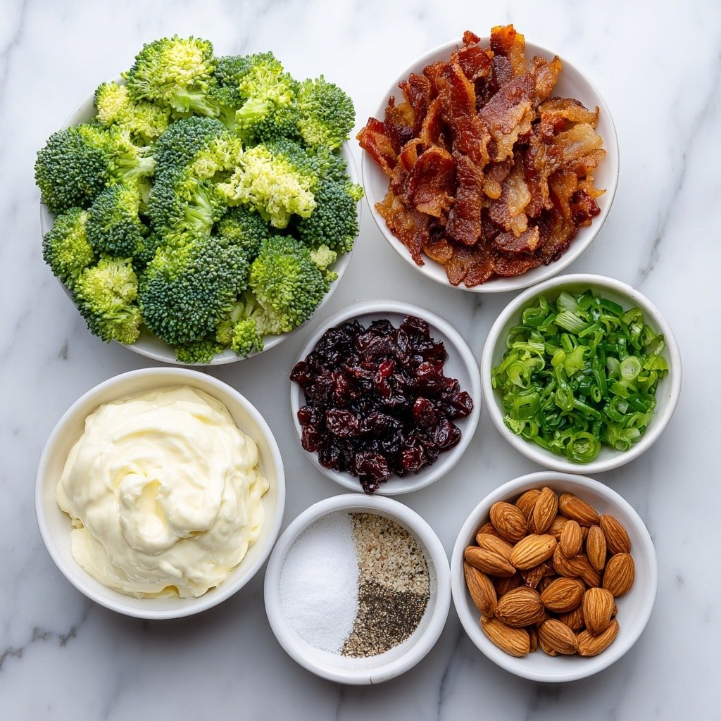 Flat lay of finely chopped fresh broccoli florets, eight slices of crispy cooked bacon chopped, a small white bowl of creamy mayonnaise, a small white bowl of granulated sugar, a small white bowl of apple cider vinegar, a small white bowl of freshly ground black pepper, a small pile of chopped red onion, a small pile of sweetened dried cranberries, and a small pile of sliced almonds, all arranged with perfect symmetry in simple white ceramic bowls and plates, placed on a clean white marble surface, soft natural light, photo taken with an iPhone, professional food photography style, fresh ingredients, white ceramic bowls, no bottles, no duplicates, no utensils, no packaging --ar 1:1 --v 7 --p m7354639359234015250 — Broccoli Salad with Bacon and Cranberries, easy broccoli salad recipe, healthy broccoli salad, crunchy bacon broccoli salad, festive broccoli salad ideas
